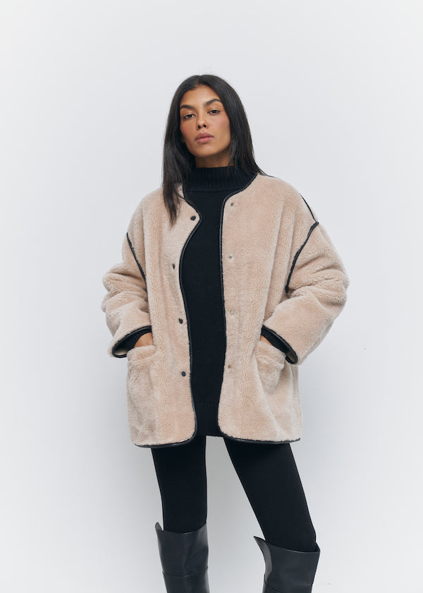 Short fur coat made of wool in beige color
