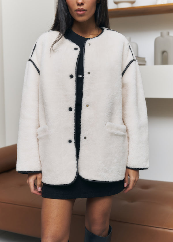 Short fur coat made of wool in milk color