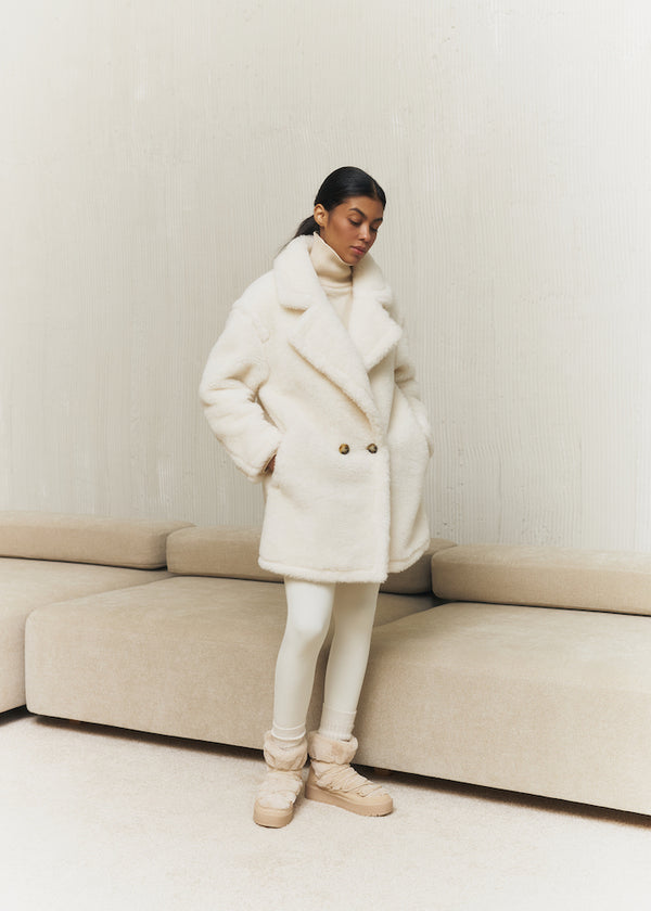 Fur coat made of natural wool in milk color