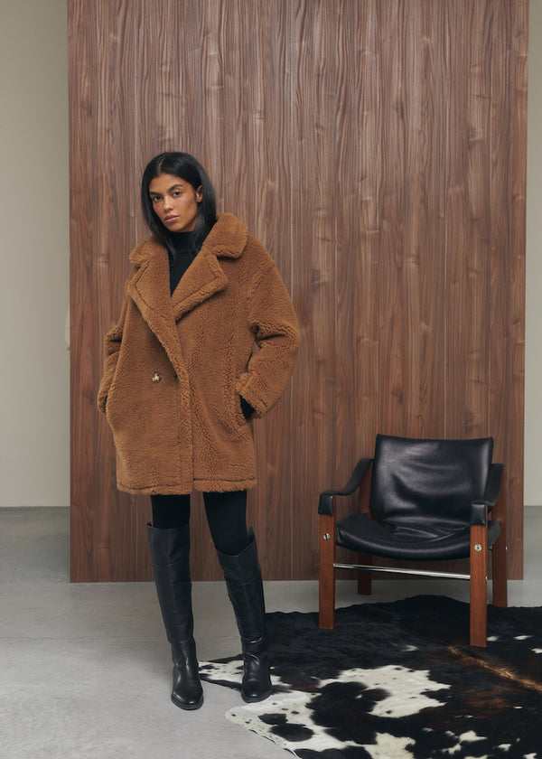 Fur coat made of natural wool in brown color